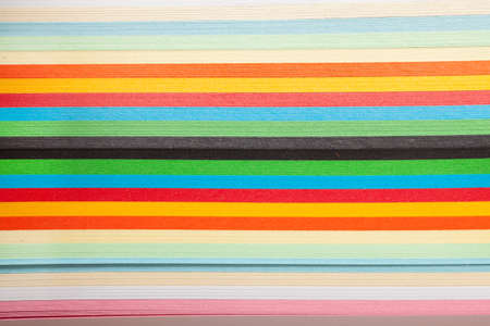 Paper strips in rainbow colors as a colorful backdrop on whiteの写真素材