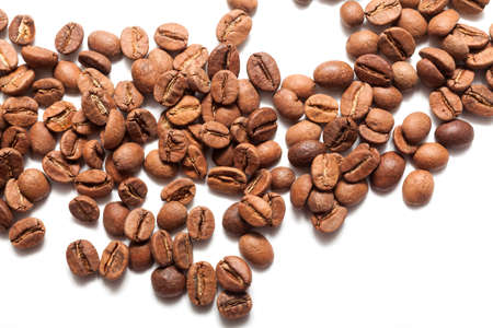 Roasted coffee beans pile on white backgroundの写真素材