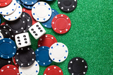 Chips for poker and dice on green backgroundの写真素材