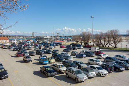 ALEXANDROUPOLIS, GREECE - FEB 3, 2015 Rows of the number of cars parked in a public parking lots in the holidays.のeditorial素材