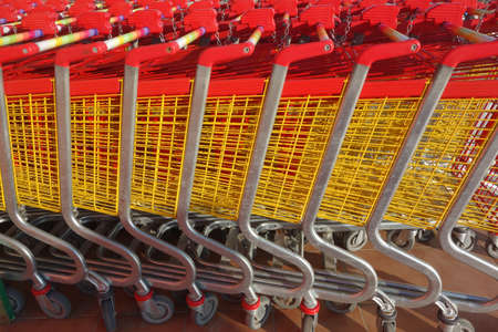 Row of supermarket shopping cart trolleys at supermarket entrance