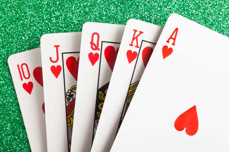 Royal flush. Playing cards isolated on a green background