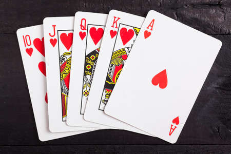 Royal flush. Playing cards isolated on a black backgroundの写真素材