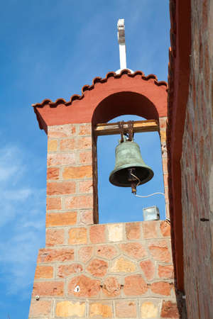 Church steeple against the blue sky in Greeceの写真素材