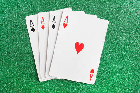 A winning poker hand of four aces playing cards suits on greenの写真素材