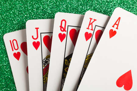 Royal flush. Playing cards isolated on a green backgroundの写真素材