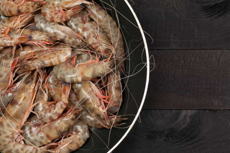 Shrimp in the pan on black backgroundの写真素材