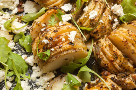 Hasselback potatoes in a baking dishの写真素材