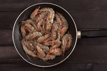 Shrimp in the pan on black backgroundの写真素材
