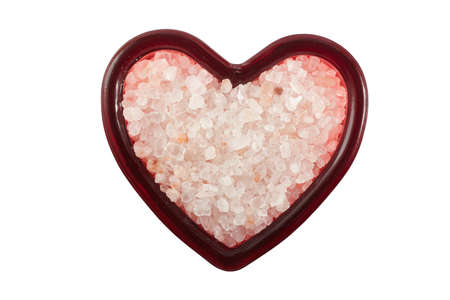 Himalayan pink salt in the heart shape container with clipping pathの写真素材