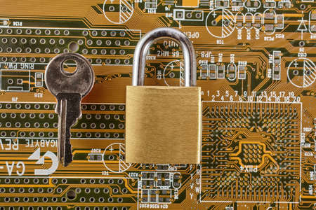 Padlock over a computer circuit boardの写真素材