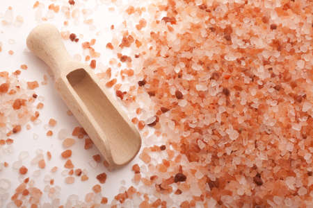 Himalayan salt and scoop on white backgroundの写真素材