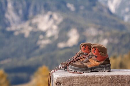 Hiking boots on a bench in the mountains closeupの写真素材
