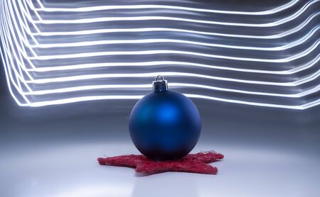 One blue christmas tree on a dark background with light effectsの写真素材
