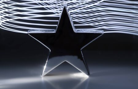 Metallic star on a black background light effectsの写真素材
