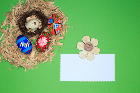 Easter decoration on green table with a memo, notepadの写真素材