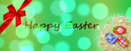 Happy easter card with painted eggs and a red bowの写真素材