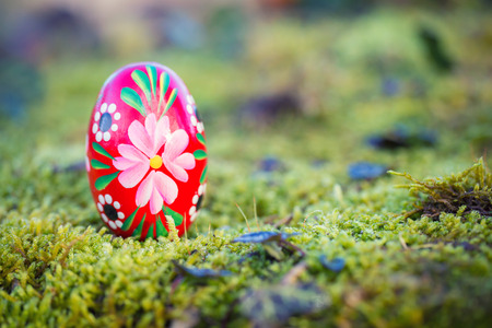 Red easter egg in a garden