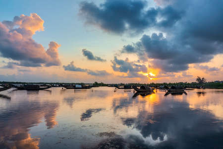 Boats in Tam Giang lagoon in sunrise in Hue, Vietnamの写真素材