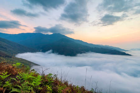 Ta Xua is a famous mountain range in northern Vietnam. All year round, the mountain rises above the clouds creating cloud inversions.の写真素材
