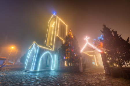 Ancient stone church of Sapa with mist night sky. Most popular traveling destination in Sapa, Laocai of Vietnamの写真素材