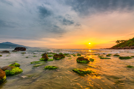 Nam O Beach, Da Nang Beach is a beautiful beach in Danang city , Vietnam. Beautiful moss rocks at the beach is interesting for travel and take a photo.の写真素材