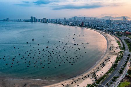 My Khe beach is a beautiful beach in Danang city , Vietnam. The sunrise is on creels , ( fishing boats in Vietnam ). My Khe Beach is in Top 6 beautiful beach in the World By Forbes Magazine.の写真素材