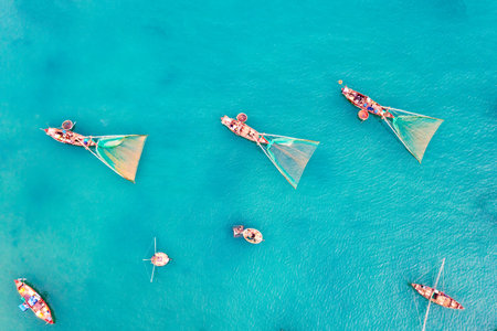 My Khe beach is a beautiful beach in Danang city , Vietnam. The sunrise is on creels , ( fishing boats in Vietnam ). My Khe Beach is in Top 6 beautiful beach in the World By Forbes Magazine.の写真素材