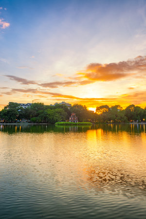Hoan Kiem Lake ( Ho Guom) or Sword lake in the center of Hanoi in cinematic sunset sky. Hoan Kiem Lake is a famous tourist place in Hanoi.の写真素材