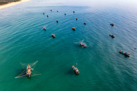 A vibrant aerial view captures the bustling activity of Binh Minh morning fish market, near Hoi An,...