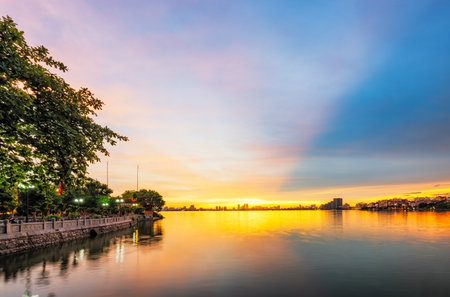 Tran Quoc Pagoda on West Lake in Hanoi, Vietnam, glows under a magnificent sunsetの写真素材