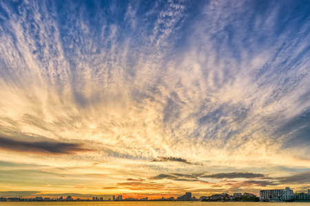 Stunning panoramic view of West Lake in Hanoi, Vietnam, glowing under a colorful sunset sky.の写真素材