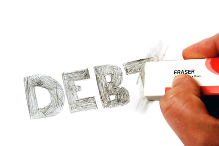 An eraser rubbing out the word debt written in pencil