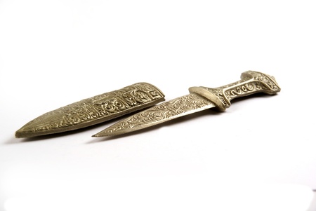 Antique bronze knife with holster isolated on white