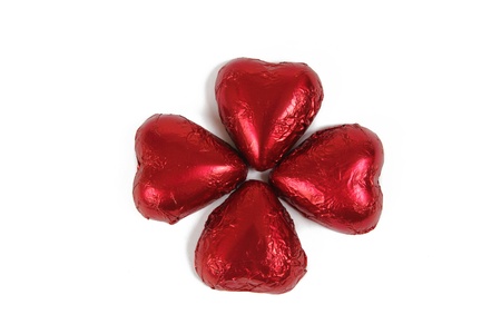 Red chocolate hearts forming a clover shape on whiteの写真素材
