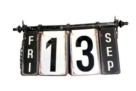 Antique metal signboard on a white background showing the words Friday the 13th