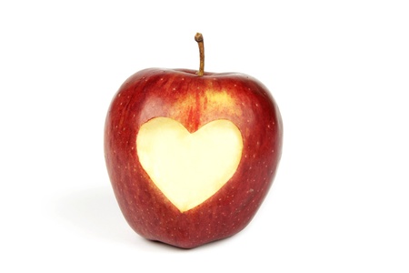 Single red apple with a heart cut out in the centerの写真素材