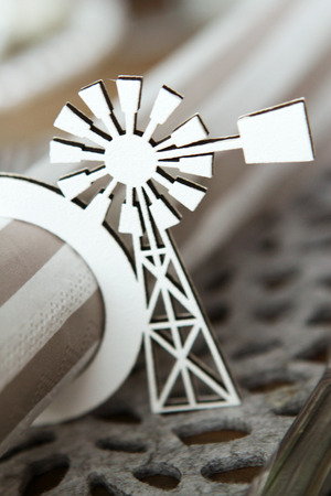 White paper windmill serviette holder cut from cardboard holding a servietteの写真素材