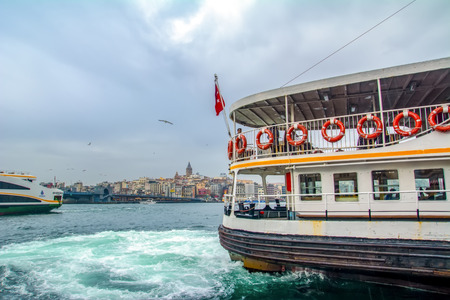 Istanbul, Turkey June 13, 2019: Muslim architecture and water transport in Turkey - Beautiful View touristic landmarks from Bosphorus. Cityscape of Istanbul at sunset - old mosque and turkish steamboats, view on Golden Horn.のeditorial素材