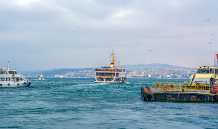 Istanbul, Turkey June 13, 2019: Muslim architecture and water transport in Turkey - Beautiful View touristic landmarks from Bosphorus. Cityscape of Istanbul at sunset - old mosque and turkish steamboats, view on Golden Horn.のeditorial素材
