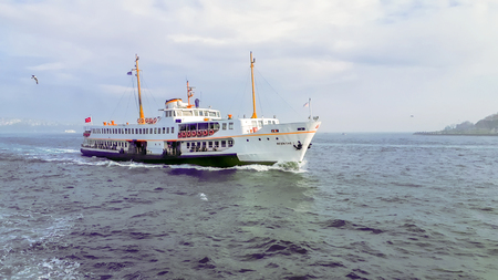 Istanbul, Turkey June 13, 2019: Muslim architecture and water transport in Turkey - Beautiful View touristic landmarks from Bosphorus. Cityscape of Istanbul at sunset - old mosque and turkish steamboats, view on Golden Horn.のeditorial素材