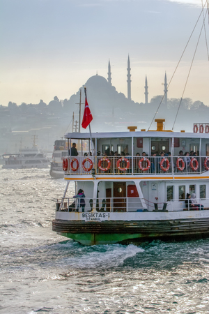 Istanbul, Turkey June 13, 2019: Muslim architecture and water transport in Turkey - Beautiful View touristic landmarks from Bosphorus. Cityscape of Istanbul at sunset - old mosque and turkish steamboats, view on Golden Horn.のeditorial素材