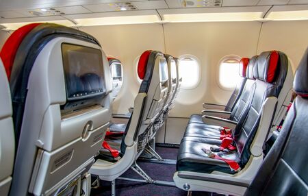 View from passenger's seat in airplane flying above clouds in dramatic sunset light. High resolution of image. Fast Travel and transportation conceptの写真素材