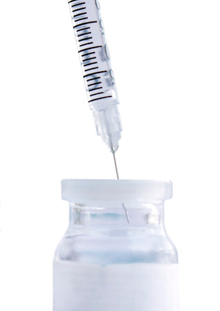 Medical syringe and vaccine vial isolated on a white background.の写真素材