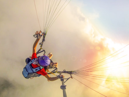 Paraglider tandem flying over the sea with blue water and mountains in bright sunny day. Aerial view of paraglider and Blue Lagoon in Oludeniz, Turkey. extreme sport. landscapeの写真素材