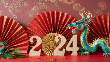 Chinese new year decoration with dragon and paper fan on red background.の素材