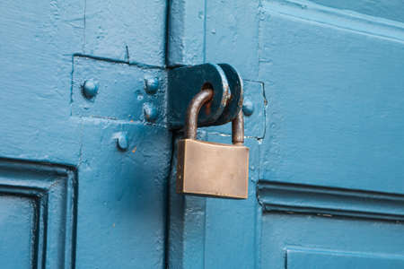 Old padlock on a wooden Blue doorの写真素材