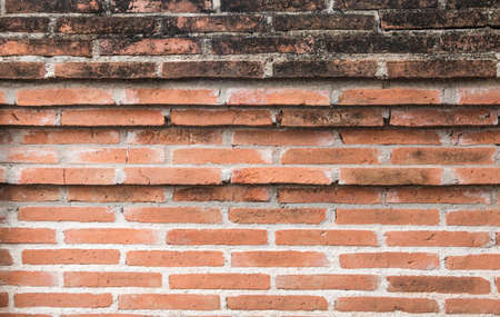 Old grunge red brick wall textured backgroundの写真素材