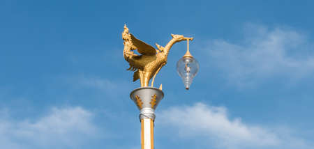 Golden swan lamp and wind bell at templeの写真素材