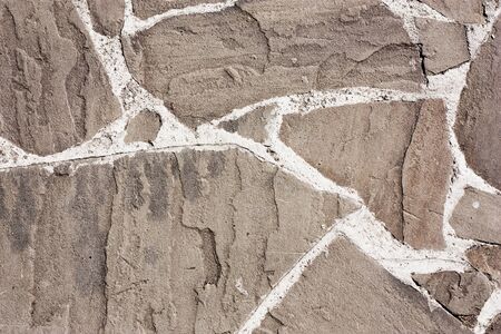 The surface of old weathered stone wall